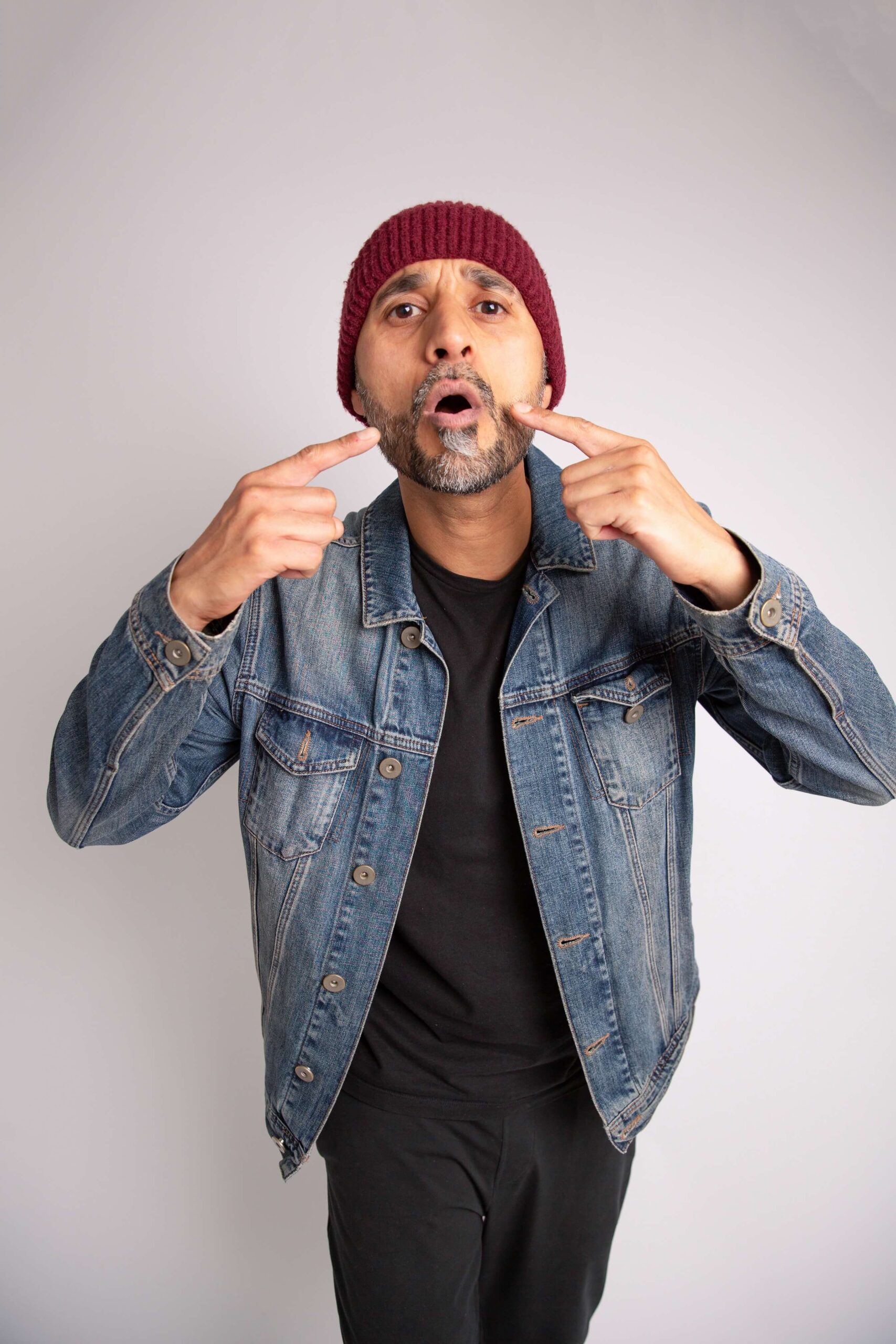 Danny pointing at mouth with both hands